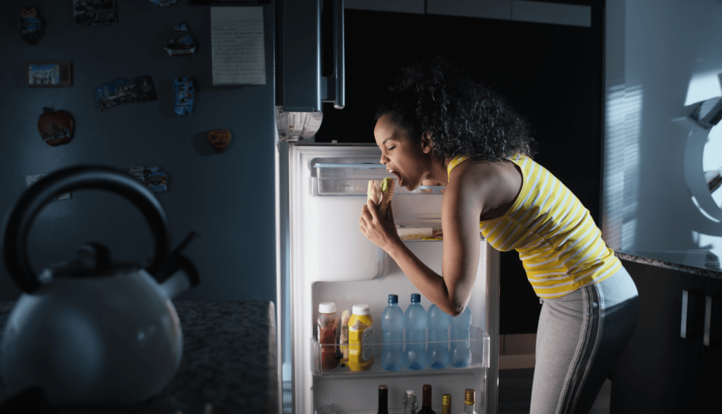 A girl eating junk food as a cheat meal